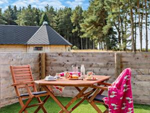 a wooden table and two chairs with food on it at 1 Bed in Lanark oc-91252 in Libberton +8 photos