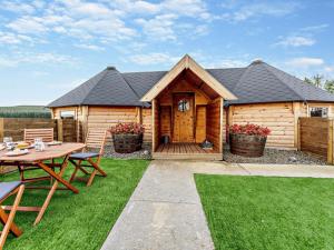 a cabin with a table and chairs in front of it at 1 Bed in Lanark oc-91248 in Libberton