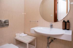 a bathroom with a sink and a mirror at RH Charming Apartment - D Nuno in Barcelos +45 photos