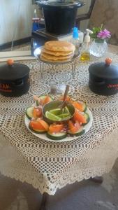 a plate of fruit and vegetables on a table at Backpack Cabin A 49149 in Oranjestad +55 photos