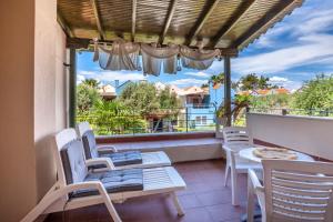 a balcony with a table and chairs and a view at Villa Portoblue Pearl in Pefkochori