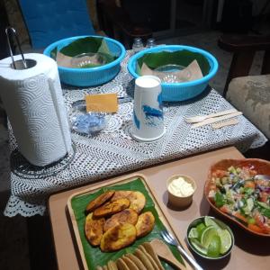 a table topped with plates of food and bowls of food at Backpack Cabin A 49149 in Oranjestad