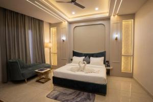 a bedroom with a bed with a flower on it at Thejaiparadise by jai hotel in Rohtak