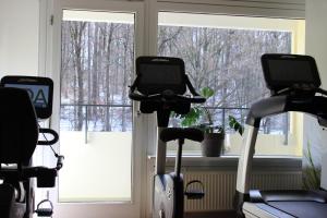 a gym with two exercise bikes in front of a window at GDA Hotel Göttingen in Göttingen