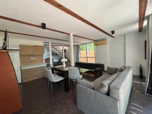 a living room with a couch and a table at Beach House Cabacum in Golden Sands