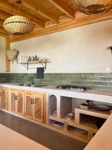 a kitchen with a sink and a counter top at Little Palm Camp in Imsouane