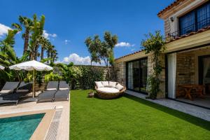 a garden with a swimming pool and a house at Moranka by ALS ALAÇATI in Alaçatı
