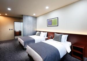 Postel nebo postele na pokoji v ubytování Geosung Hotel