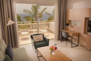 a living room with a view of the ocean at Plus Fariones Suite Hotel in Puerto del Carmen
