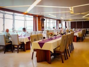 a restaurant with tables and chairs and people sitting at them at Donyi Polo International in Itānagar