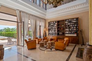 an ornate living room with chairs and bookshelves at Bab Akoul Atlas - Boutique Hotel & Spa in Aït Namous