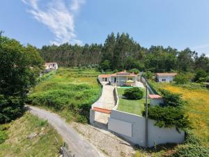 a house in the middle of a field at Casal do Porto - Um refugio de férias in Vila Verde
