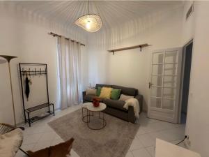 a living room with a couch and a table at Monaco Cote d Azur in Beausoleil