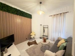 a living room with a couch and a tv at Monaco Cote d Azur in Beausoleil