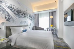 Letto o letti in una camera di YELLO Hotel Harmoni