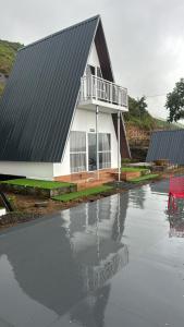 a house sitting on top of a flooded street at Varattumedu Hill in Vagamon +20 photos