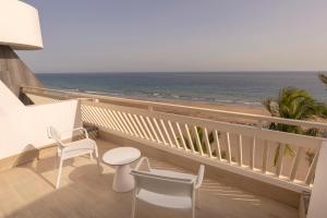 a balcony with a view of the beach at Plus Fariones Suite Hotel in Puerto del Carmen