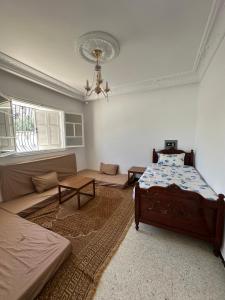 a living room with a bed and a couch at villa Flamingo in Sousse