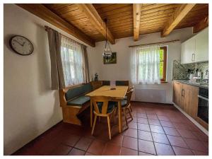 a kitchen and dining room with a table and a clock at Nalas Auszeit in Regen +22 photos
