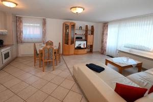 a living room with a couch and a table at Bernstein Mare-Comfort Wohnung 5 in Büsum