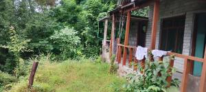 a house with clothes hanging on a fence at Nothing in Kulu