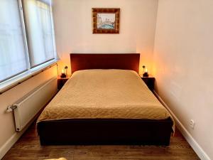 a bedroom with a bed with two lamps on the sides at Villa Del Mar in Jūrmala