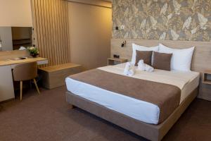 a hotel room with a large bed and a desk at Hotel Kragujevac in Kragujevac +54 photos