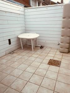 a small white table sitting on a patio at Les Volets Blancs in Étaples