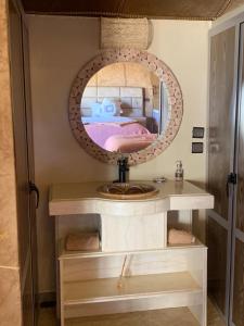 a mirror on a shelf with a bed in a room at Unique Luxury Camp in Merzouga +54 photos