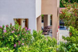 a group of chairs sitting outside of a building with flowers at Philoxenia Hotel in Skala Prinou