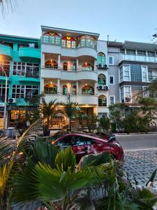 a building with a car parked in front of it at Palmscape Boutique Hotel in Hulhumale