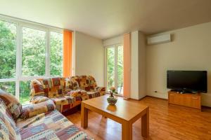 a living room with two couches and a tv at Tranquil condo in Golden Sands in Varna City