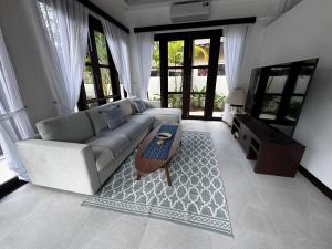 a living room with a couch and a coffee table at Villa Mirada Maenam - Renovated Four Bedroom with Private Pool in Nathon Bay