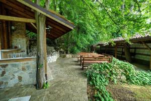 a group of wooden benches sitting under a pavilion at Tranquil condo in Golden Sands in Varna City