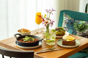 a wooden table with plates of food on it at Zoku Paris in Paris