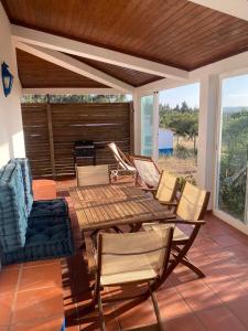 a patio with a wooden table and chairs at Casa Nova da Corte Salva in Grândola