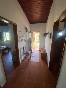 a hallway of a house with a door and a chair at Casa Nova da Corte Salva in Grândola