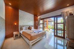 a bedroom with a large bed in a room at The Pulau Bungalow in Nusa Lembongan +101 photos