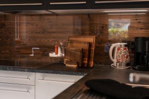 a kitchen with wooden walls and a counter top at Chalet Resort Innerluferhof in Rifiano +64 photos
