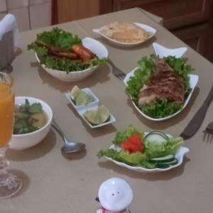 a table with plates of food on a table at Backpack Cabin A 49149 in Oranjestad