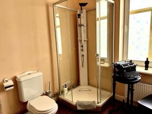 a bathroom with a shower with a toilet and a camera at Villa Del Mar in Jūrmala