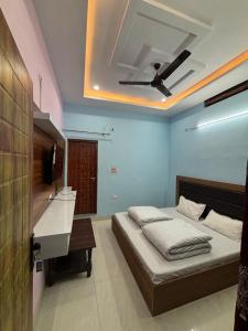 a bedroom with a bed and a ceiling at Hotel Om Palace in Ukhimath
