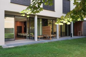 a glass extension of a house with tables and chairs at Hotel Wallern Garni in Wallern an der Trattnach