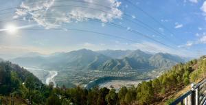 a view of a valley with a river and mountains at The City View Homestay in Srīnagar