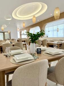a dining room with wooden tables and chairs at SUSMED Dąbki in Dąbki