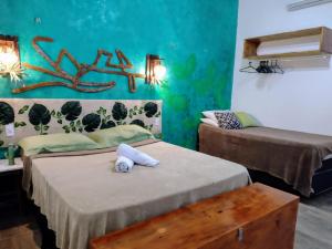 a room with two beds and a table in it at Casa 3 amores PREÁ, vento, charme, piscina e 2 quartos in Prea +28 photos