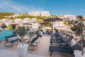 a row of chairs and tables on the roof of a building at Atelier in Ulcinj