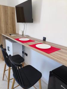 a desk with two chairs and a television on it at Seaview Apartment in Galissas - Blue Lagoon Complex A9 in Galissas
