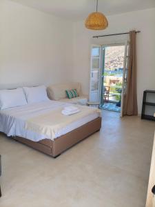 a bedroom with a bed and a door to a patio at Seaview Apartment in Galissas - Blue Lagoon Complex A9 in Galissas