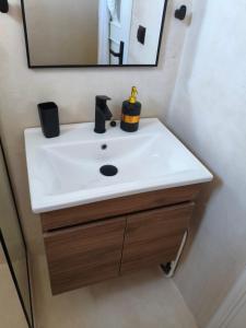 a bathroom with a white sink and a mirror at Seaview Apartment in Galissas - Blue Lagoon Complex A9 in Galissas +15 photos